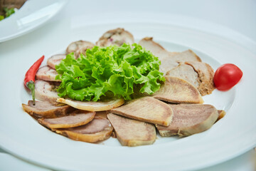 Meat cuts on a plate. Beautiful serving of food in a restaurant.