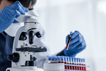 Laboratory and science experiments, chemical hand taking a blood sample tube from a rack analysis lab test in laboratory.