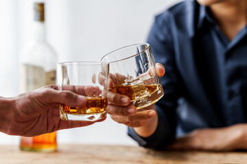 Sad depressed addicted drunk guy, Alone asian man drinker alcoholic sitting at bar counter with glass drinking whiskey.