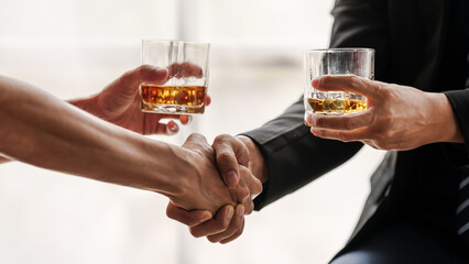 Sad depressed addicted drunk guy, Alone asian man drinker alcoholic sitting at bar counter with glass drinking whiskey. shaking hands.