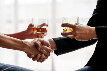 Sad depressed addicted drunk guy, Alone asian man drinker alcoholic sitting at bar counter with glass drinking whiskey. shaking hands.