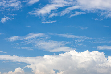 Naklejka na ściany i meble Sunny blue sky with dramatic white clouds