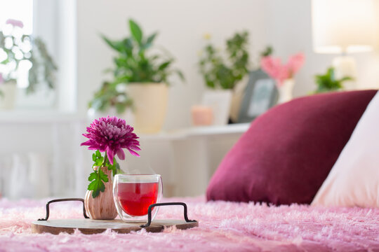 red tea in thermo glass with flowers in modern bedroom