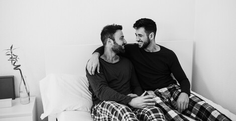 Happy gay men couple having tender moments at home - Focus on right man face - Black and white...