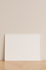 Clean and minimalist front view horizontal white photo or poster frame mockup leaning against wall on wooden floor. 3d rendering.