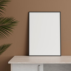 Minimalist front view vertical black photo or poster frame mockup leaning against wall on table with plant. 3d rendering.