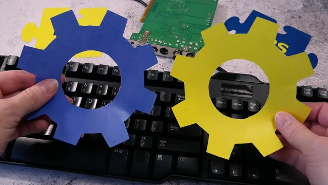 Dev and Ops symbol in hand on motherboard and keyboard background. DevOps Concept for software engineering culture and practice of software development and operation