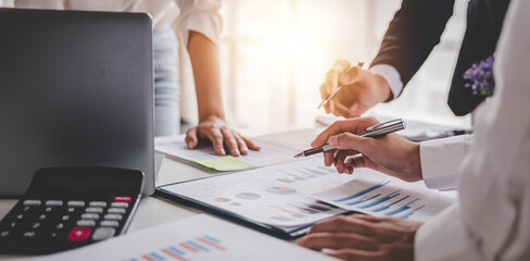 Young colleagues discuss business brainstorming and price charts analyze business people at the desk brilliantly in modern collaborative office teamwork ideas. Calculate personal tax for customers