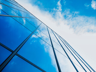 Fototapeta na wymiar Modern building Glass facade with Sky reflection Architecture details