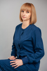 Woman portrait in blue suit on background studio