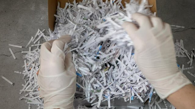 Top secret information on retro vintage floppy disk magnetic computer among shredder paper, thief information concept