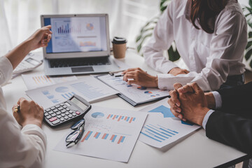 Young colleagues discuss business brainstorming and price charts analyze business people at the desk brilliantly in modern collaborative office teamwork ideas. Calculate personal tax for customers