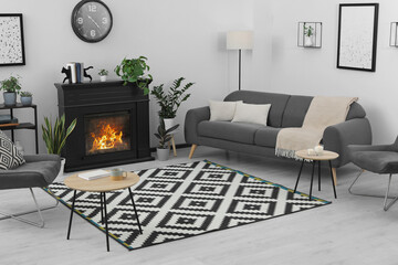 Naklejka premium Stylish living room interior with fireplace and comfortable sofa