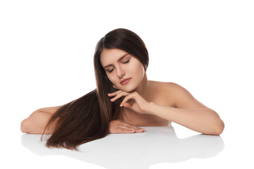 Obraz premium Young woman with strong healthy hair on white background