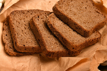 still life of food in a rural style on a dark wood background, sliced rye bread, concept of fresh vegetables and healthy food