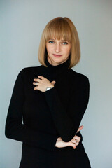 Beautiful blonde businesswoman portrait in black dress on background