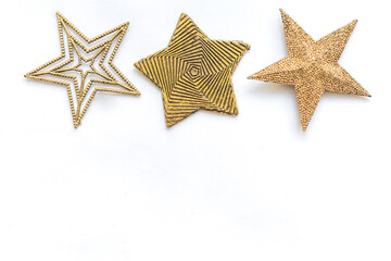 Fototapeta na wymiar Golden stars on a white background located on top with copy space for text