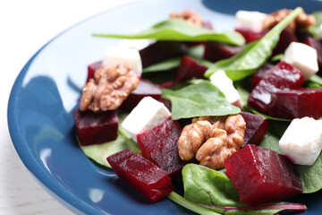 Fresh delicious beet salad on plate, closeup