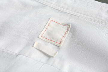 Blank clothing labels on white shirt, closeup