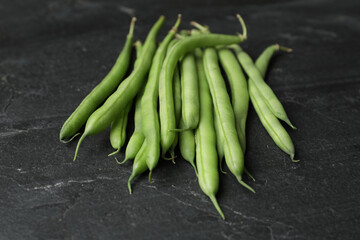 Fresh green beans on black table, closeup