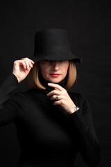 Woman in black dress and hat on background