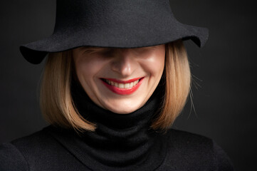 Woman in black dress and hat on background