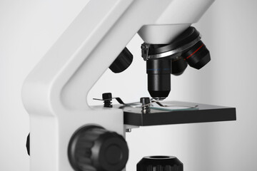 Fototapeta na wymiar Modern microscope on light background, closeup. Medical equipment