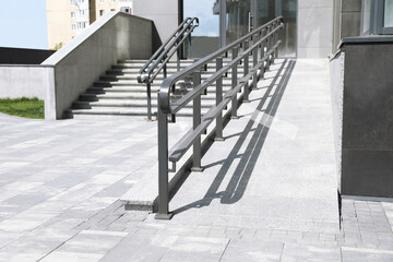 Outdoor stairs with ramp and metal railing - Powered by Adobe