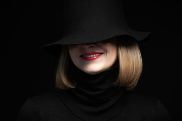 Woman in black dress and hat on background