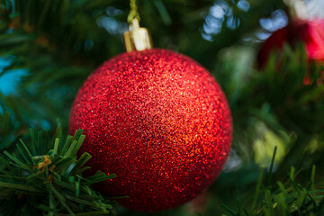 Red balls that decorate the Christmas tree.