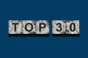 Top 30, words, above different numbers, on a dark blue background. Alphabet on stone blocks.Rating. Rating concept.