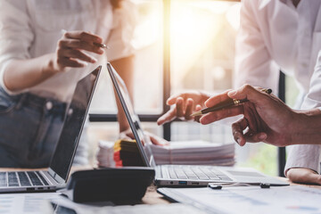 Young colleagues discussing business and price chart analyzes business people on the table great in modern coworking office teamwork concept. Calculate personal tax for customers