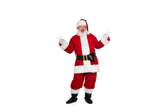 Portrait of cheerful senior man in image of Santa Claus posing with positive emotion isolated over white background