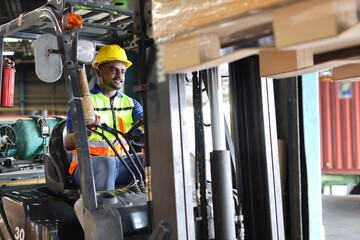 Warehouse workers or forklift driver man with hardhats and reflective jackets in vehicle using...