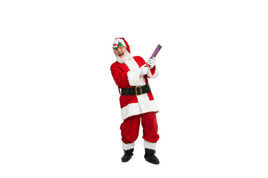 Portrait of senior man in image of Santa Claus posing in festive glasses and confetti flapper isolated over white background
