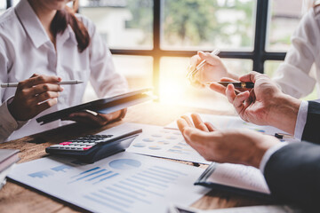 Young colleagues discussing business and price chart analyzes business people on the table great in modern coworking office teamwork concept. Calculate personal tax for customers