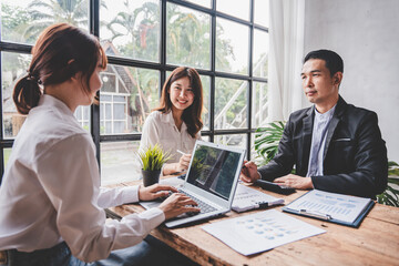 Young colleagues discussing business and price chart analyzes business people on the table great in modern coworking office teamwork concept. Calculate personal tax for customers
