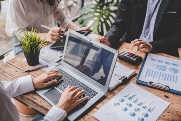 Young colleagues discussing business and price chart analyzes business people on the table great in...