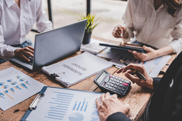 Young colleagues discussing business and price chart analyzes business people on the table great in...