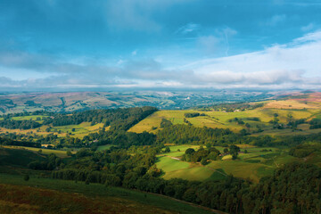 Fototapeta na wymiar Panorama of welsh countryside. British landscape. Aerial panoramic view of typical british farmers fields and some sheep. England UK. Scenic British Countryside at Summer. 
