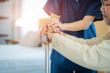Caregiver hold hand of senior man patient give comfort,Express health care sympathy at nursing...