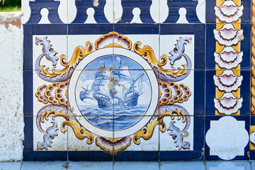 azulejo panels on a stone bench telling of maritime life in Olhao, Faro district Algarve, Portugal