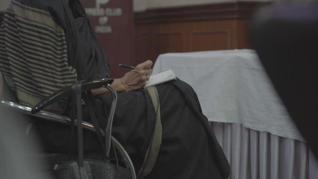Women journalist is taking her notes during a Press Conference in Delhi capital
