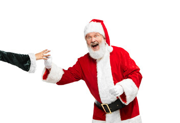 Portrait of senior man in image of Santa Claus putting ring on woman's hand isolated over white background
