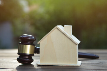 Real estate and protecting insurance concept - Invest to a family home. House model and judge gavel