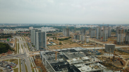Obraz premium Construction site of a new city block. Construction of multi-storey buildings. Overcast weather. Aerial photography.