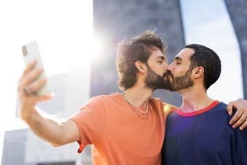 Gay couple embracing and showing their love. Men taking selfie photo.