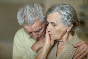 Portrait of a elderly couple being sad together