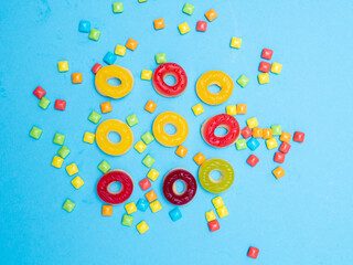 Multicolored marmalade sweets on a blue background