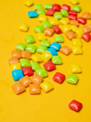 Multicolored marmalade sweets on a yellow background. 
